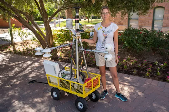 Ariane Middel stands beside one of her MaRTy mobile heat sensing devices at Arizona State University in Tempe.